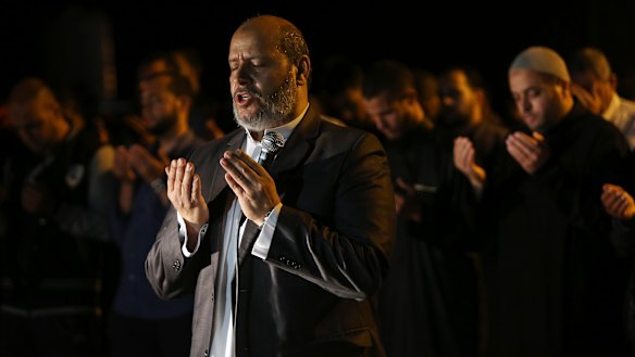Hamas leader Khalil al-Hayya, leads an evening prayer  marking the first eve of the holy fasting month of Ramadan, outside the tents of the protest camp near the Israeli border east of Gaza City.