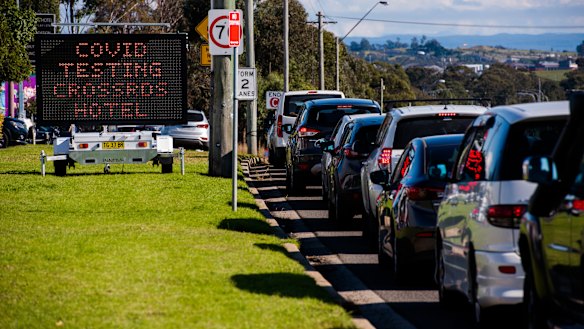 Patrons wait in a long queue to be tested for COVID-19 outside the Crossroads Hotel in Casula.