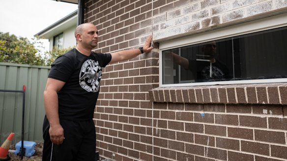 ANSA Homes client Kevin Bezzina points to defective brickwork which was subject to a Building Commission-enforced rectificiation order.
