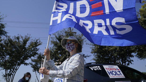 A woman shows her support of Democratic presidential candidate former vice-president Joe Biden by holding a flag in Plano, Texas. 