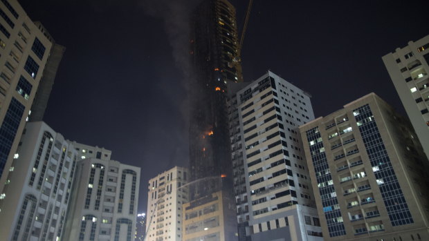Civil defence forces extinguish a fire that broke out at a high-rise building in Sharjah, United Arab Emirates.