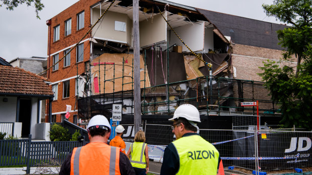 A major section of the four-storey building in Crows Nest collapsed after workers fled on Monday afternoon.