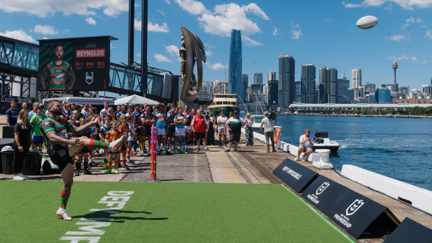 Adam Reynolds launches a kick at Thursday’s NRL Launch at White Bay Cruise Terminal.