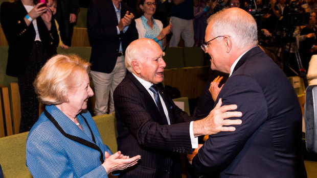 Scott Morrison greets former prime minister John Howard, with wife Janette, after his speech.