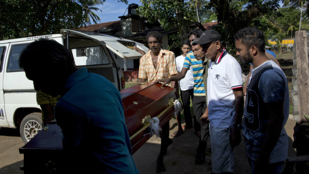 People carry the coffin with the remains of 12-year-old Sneha Savindi, who was a victim of Easter Sunday bombing at St Sebastian Church.