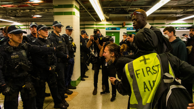 The woman in front of the police line at Central Station.