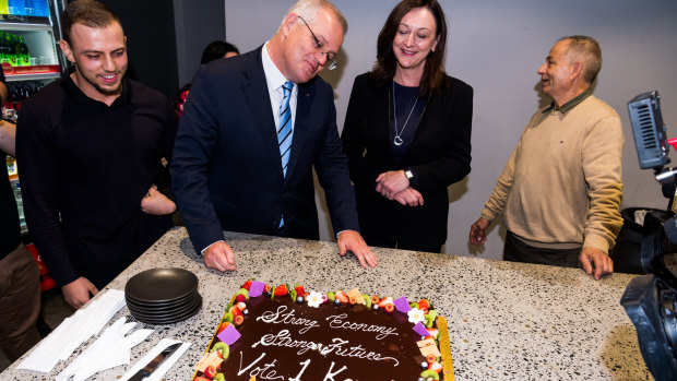 Prime Minister Scott Morrison appraises his ‘Strong economy, strong future’ cake at Abla’s Pastries in Granville in the seat of Parramatta on Thursday.