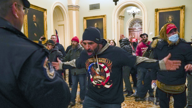 Trump supporters confront US Capitol Police in the hallway outside of the Senate chamber at the Capitol in Washington.