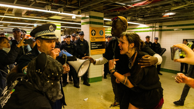 The woman confronts police.