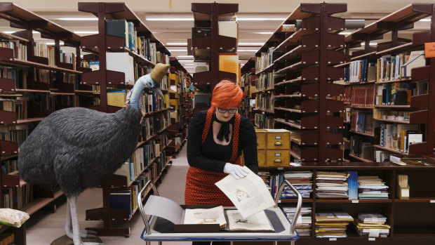 Librarian Adria Castellucci pictured with the book Icones Animalium by Conrad Gessner, published in 1560 and one of the oldest books held in Australia.