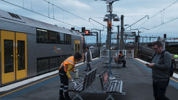 Seating is cleaned on Milsons Point Train station platform on Monday.