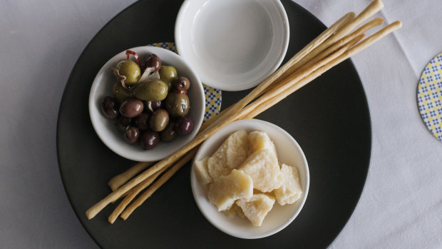 A classic Italian starter – marinated olives, Parmigiano reggiano and grissini.
