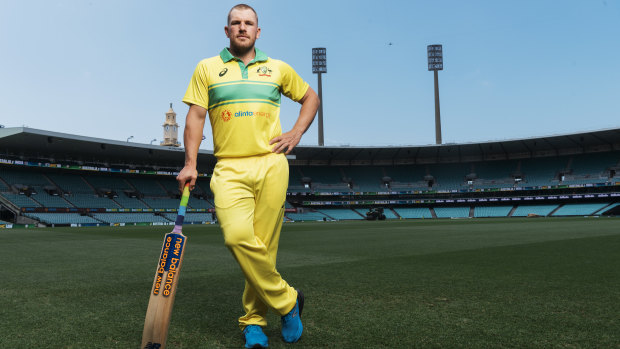Australian captain Aaron Finch showing off his team's 1986 replica one-day playing kit that will be worn on Saturday at the SCG.