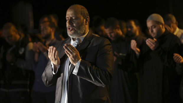 Hamas leader Khalil al-Hayya, leads an evening prayer  marking the first eve of the holy fasting month of Ramadan, outside the tents of the protest camp near the Israeli border east of Gaza City.