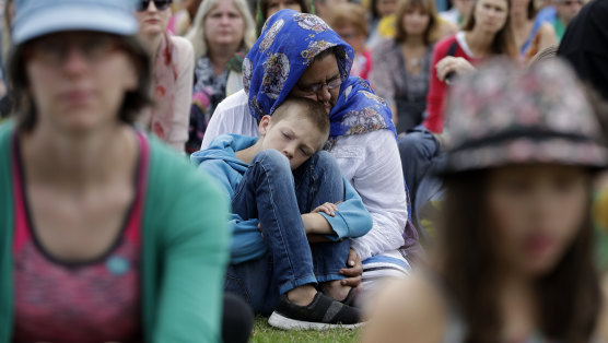 A woman embraces a boy at a March 23 'March for Love' following the mosque attacks in Christchurch.