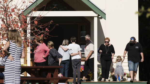 Members of the Margaret River community leaving flowers at the community resource centre.