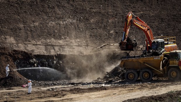 Crews working on the smouldering landfill in September last year.