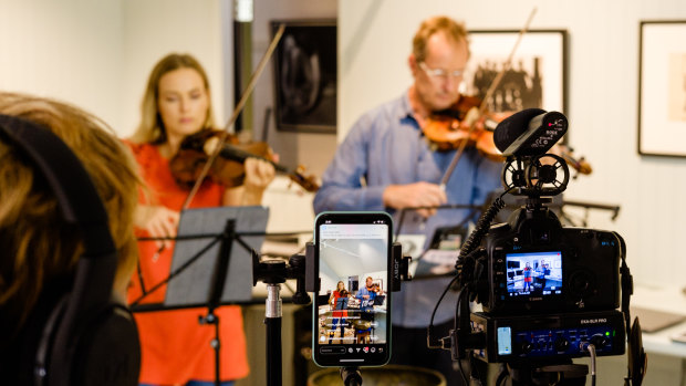 Working from home: Satu Vanska and Richard Tognetti perform in their Manly lounge room.