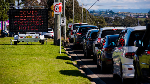 Patrons wait in a long queue to be tested for COVID-19 outside the Crossroads Hotel in Casula.