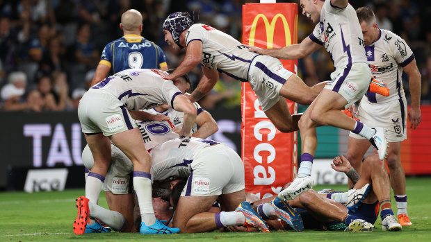 The Storm celebrate Harry Grant’s match-winning try.