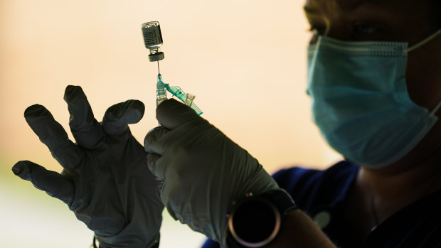 A syringe is prepared with the Pfizer COVID-19 vaccine at a clinic in Pennsylvania.