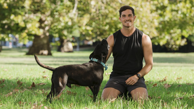 Sydney-based exercise physiologist Drew Harrisberg with his dog Dennis, who suffers from chronic gut issues.