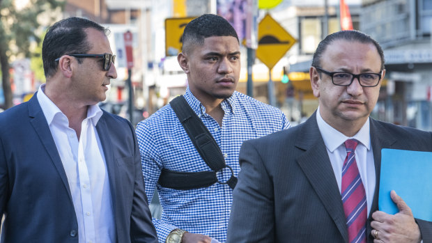 Manase Fainu (centre) arrives at Liverpool police station with manager Mario Tartak (left) and legal representative Elias Tabchouri.