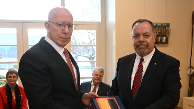 Royal Commission chair Nick Kaldas (right) delivers an interim report on Defence and veteran suicide to Governor-General David Hurley (left) with fellow commissioners Peggy Brown and James Douglas.