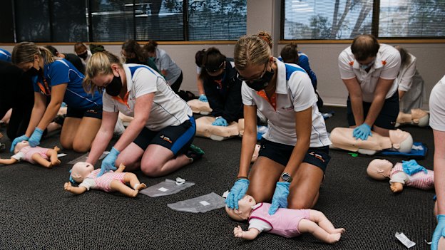 Students practise CPR for children (front) and adults (back) on “Annie” dummies during a class at Carlile Swimming in Lane Cove West. 