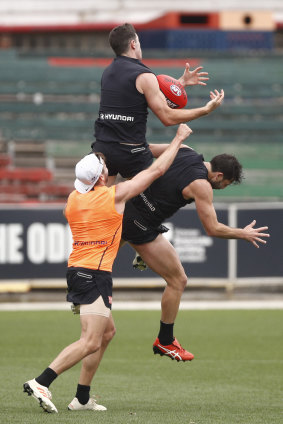 Mitch McGovern flies for a mark over Alex Fasolo, fracturing his back upon landing.