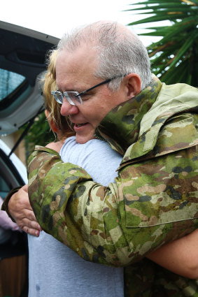 Mr Morrison hugging a Townsville resident.