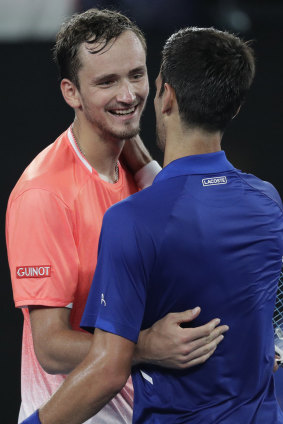 Djokovic is congratulated by Russia's Daniil Medvedev, after winning their fourth round match.
