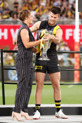 Ash Barty presents the 2020 AFL premiership cup to Trent Cotchin in Brisbane.