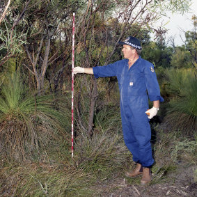 Former forensic supervisor Robert Hemelaar measuring where tree branches had been ripped off near where Ciara's body was found. 