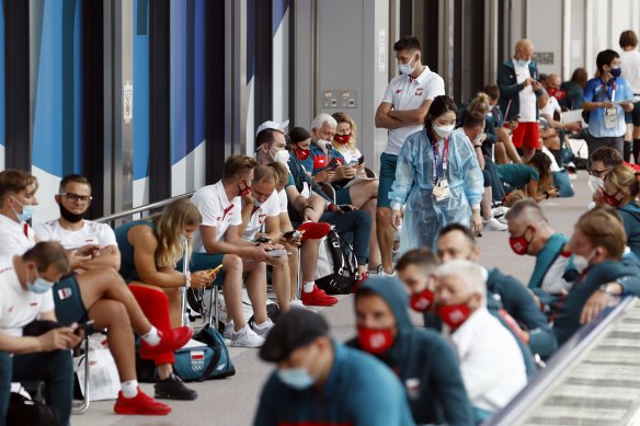 Poland’s team wait for COVID-19 testing upon arrival in Tokyo.