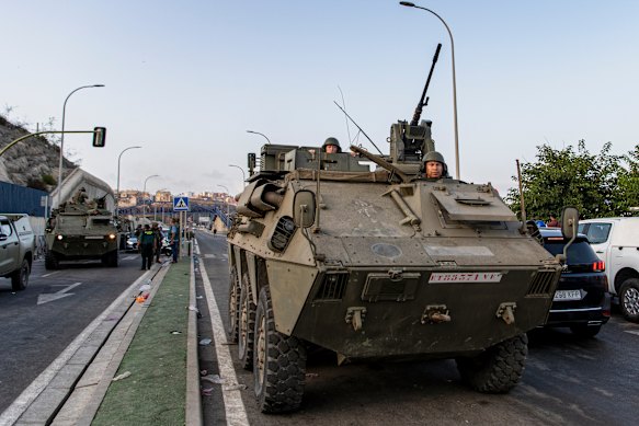 Spanish soldiers travel in military vehicles after being deployed to Ceuta.