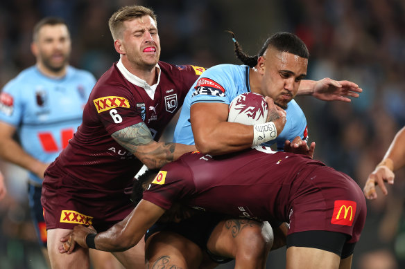 Keaon Koloamatangi is tackled by Cameron Munster. 