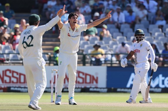 Australia’s captain Pat Cummins, and teammate Travis Head, claim the wicket of South Africa’s captain Temba Bavuma, right, on day three of the third Test match between South Africa and Australia, in Cape Town.