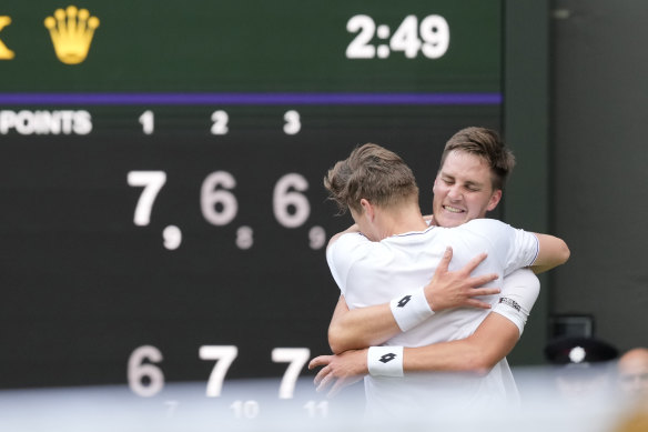 Harri Heliovaara of Finland, left, hugs playing partner Henry Patten of Britain on winning the championship point.