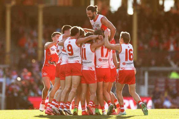 Luke Parker is mobbed by teammates after kicking his first goal against North.