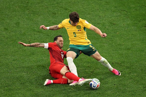 Jordan Bos #5 of Australia is challenged by Hakan Calhanoglu #10 of Turkiye.