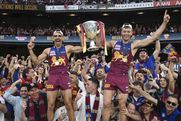 Brisbane Lions stars Charlie Cameron and Josh Dunkley with the 2024 premiership cup.