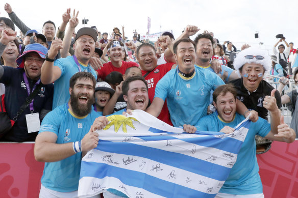 Triumphant Uruguayan players celebrate with the crowd after their stunning defeat of Fiji.