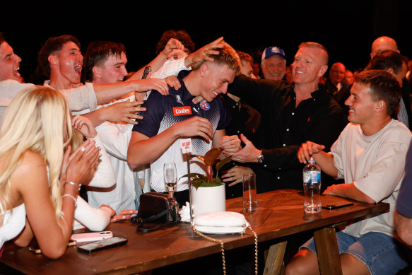 Caddy celebrates with family and friends after being picked up by the Bombers.