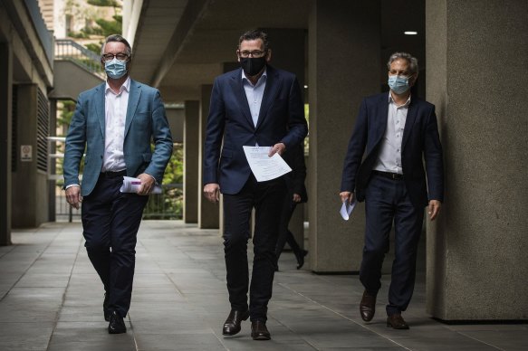 Victorian Health Minister Martin Foley, Victorian Premier Daniel Andrews and Victorian Chief Medical Officer Brett Sutton arrive at the daily press conference on Sunday.