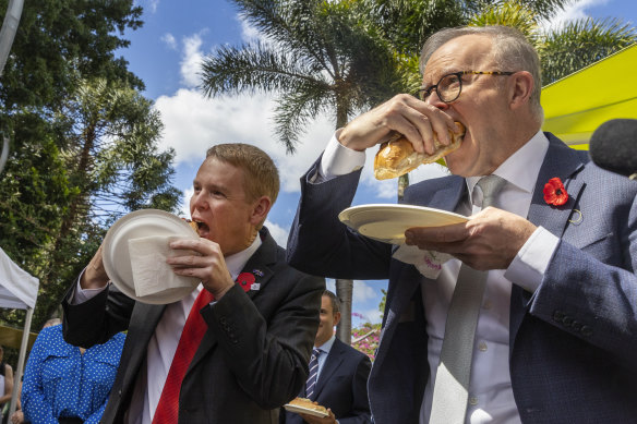Chris Hipkins, left, and Australian Prime Minister Anthony Albanese tuck in at a citizenship ceremony in Brisbane.