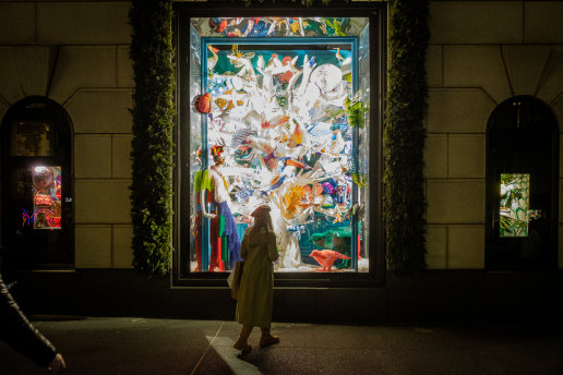 A pedestrian views the holiday windows at the Bergdorf Goodman department store in New York.