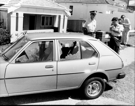 A police officer stands guard over   slain consular bodyguard Engin Sever's car on December 17, 1980