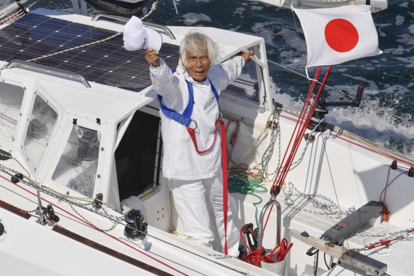 Japan’s Kenichi Horie waves on his sailing boat after his trans-Pacific voyage, at Osaka Bay, western Japan, Saturday, June 4, 2022. The 83-year-old Japanese adventurer returned home Saturday after successfully completing his solo, nonstop voyage across the Pacific, becoming the oldest person to reach the milestone.