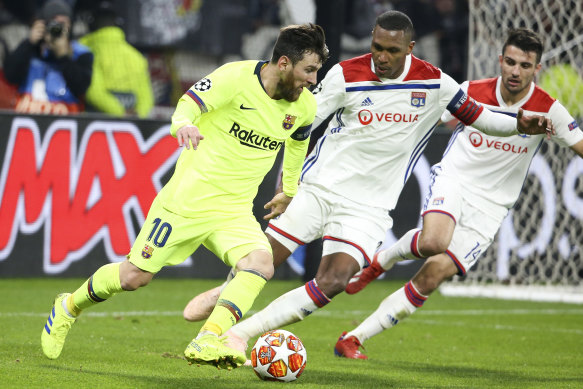 Marcelo, during his days with Olympique Lyonnais, keeps a close eye on Lionel Messi.
